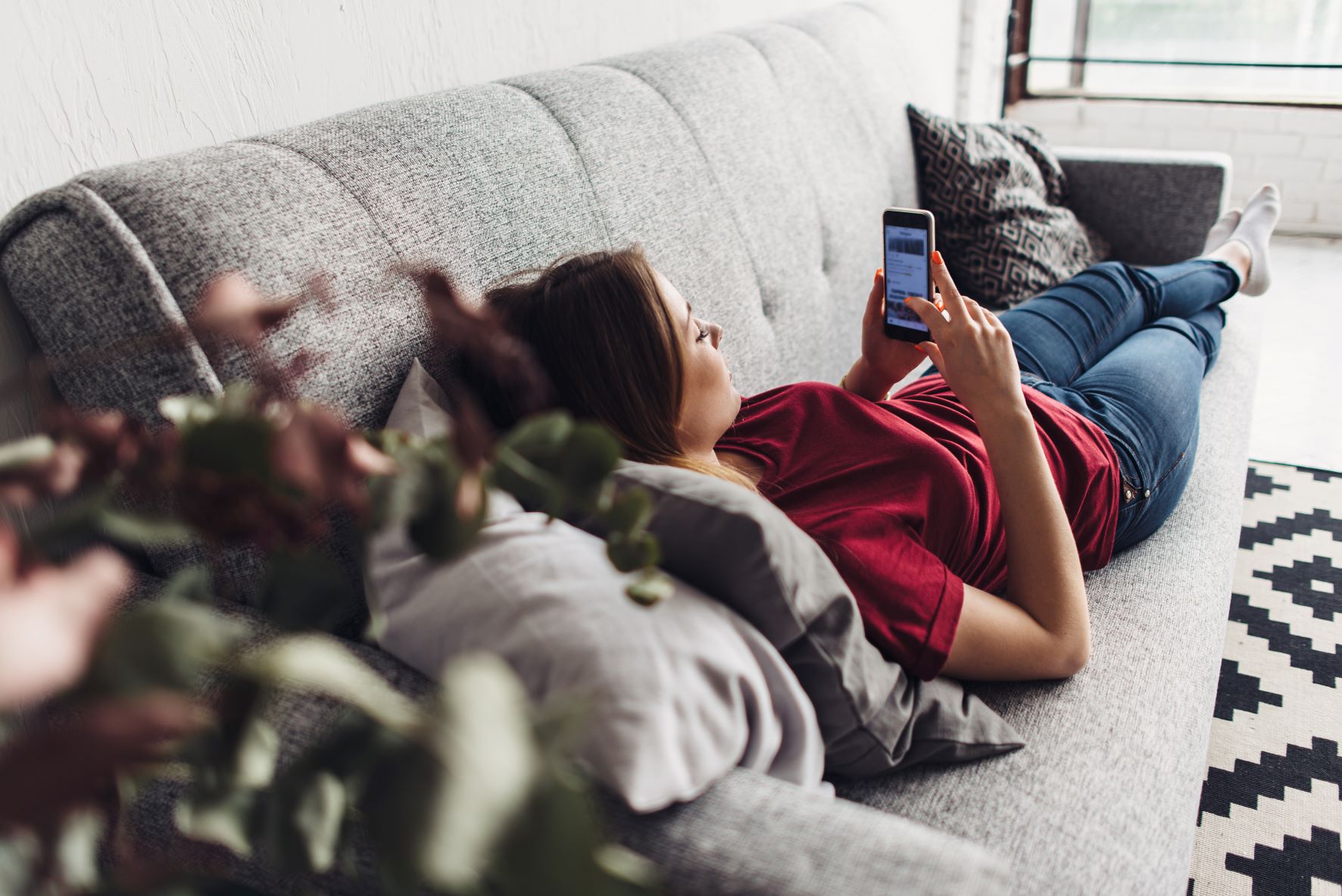Woman on sofa with phone